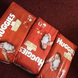 3 packs and 2 boxes of Huggies Newborn Diapers